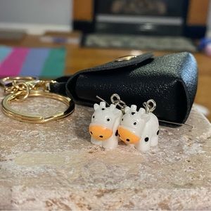 Brand new cow earrings packaged in a cute black clutch keychain!